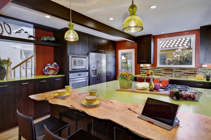A kitchen with vibrant green counter tops.