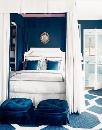 An interior tribute to blue with a canopy bed.