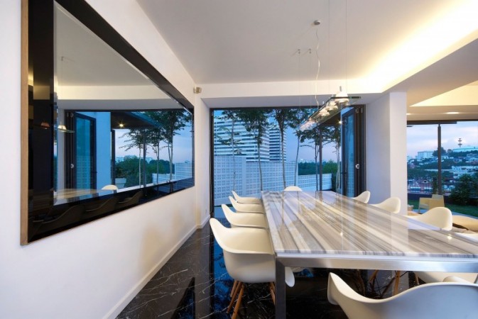 A dining room with a large mirror.