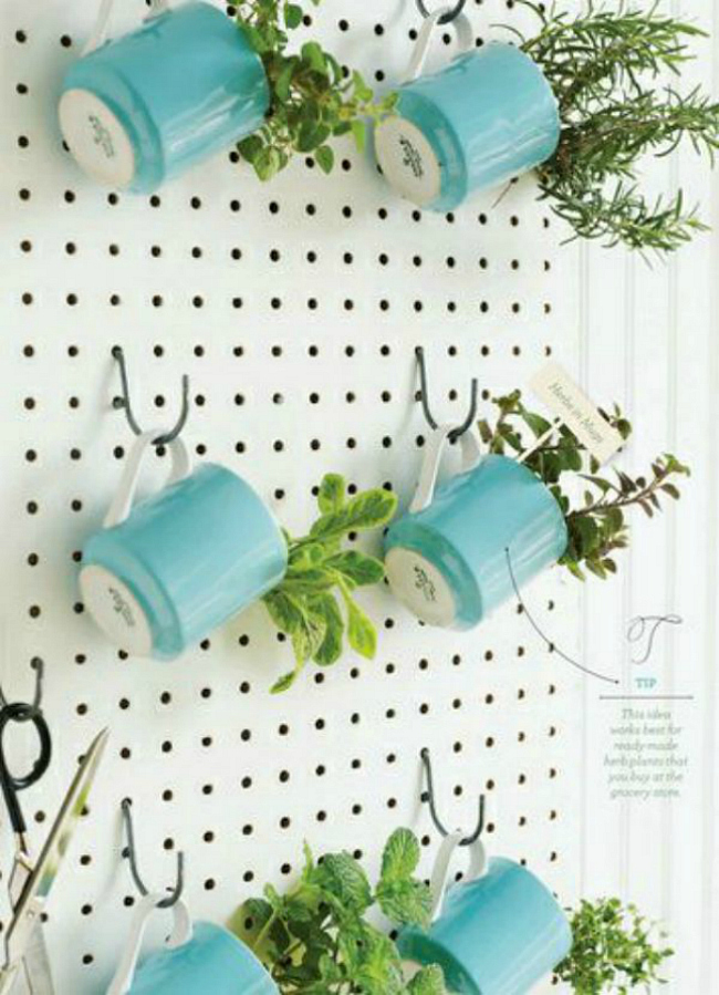 An herb garden with pots of herbs hanging on a pegboard.