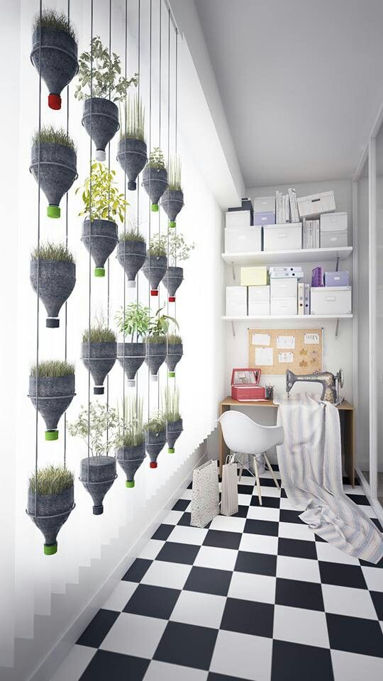 A bedroom with plants hanging from the ceiling to create a black and white herb garden.