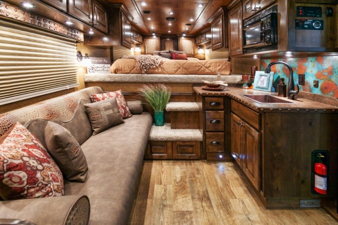 An unconventional horse trailer conversion featuring a couch and bed.