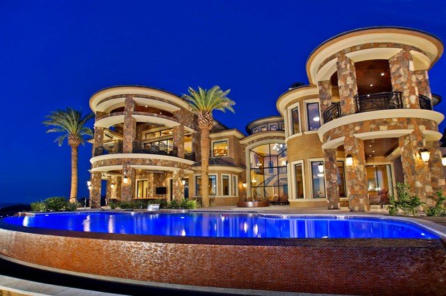 A large mansion with a pool at night offers a luxurious and dreamy atmosphere.