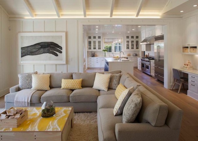 A living room with a gray couch and yellow accents featuring a modern farmhouse style.