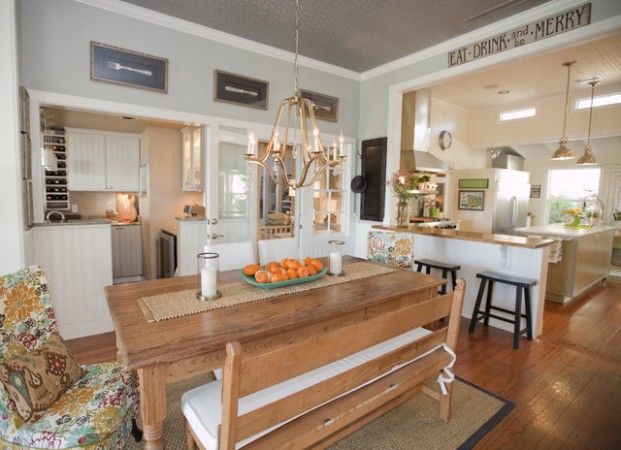 A modern farmhouse style kitchen with a wooden table and chairs.