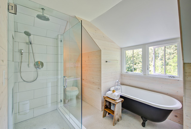 A modern farmhouse style bathroom featuring a bathtub and a glass shower.