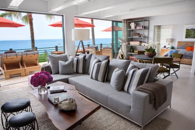 An understated living room with an elegant coastal design and a view of the ocean.
