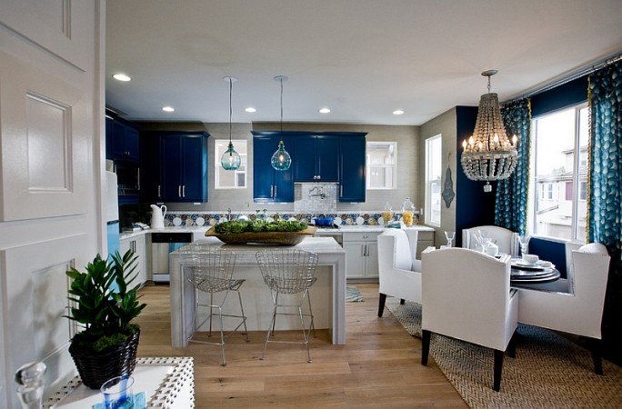 White cabinets against dark blue walls create a stunning contrast 