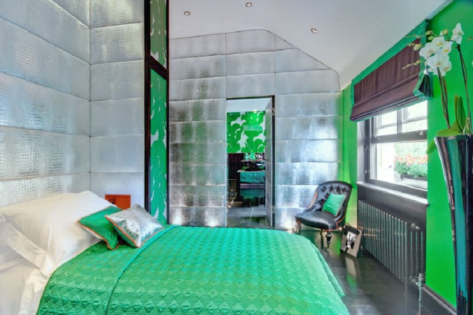 A bold and wonderful green and silver bedroom with a bed to inspire.