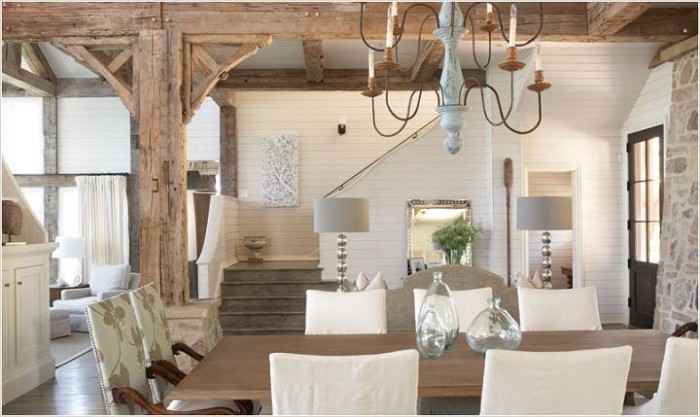 A dining room with understated elegance featuring wooden beams and a chandelier.