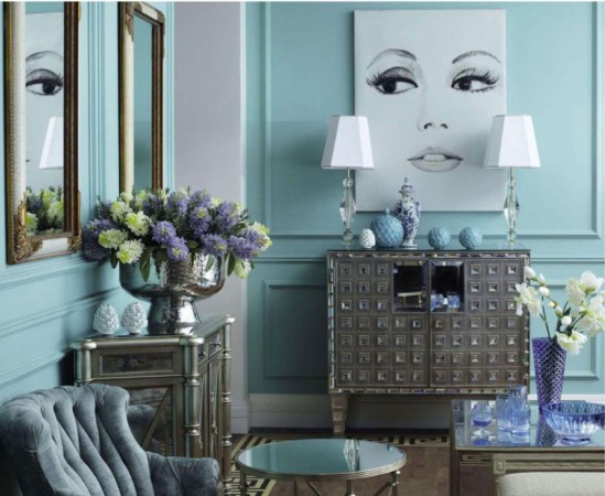 An Interior Design Tribute to Blue: A living room with blue walls and a large painting.
