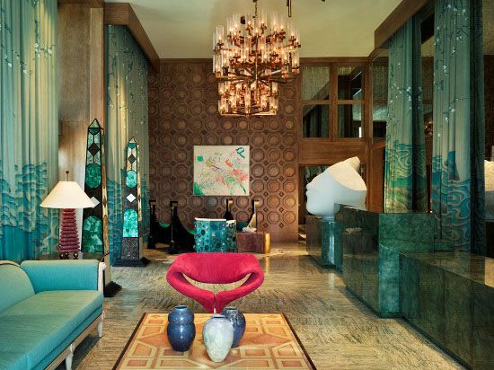 The lobby of a hotel is decorated in bold turquoise and blue, creating a wonderful interior to inspire.