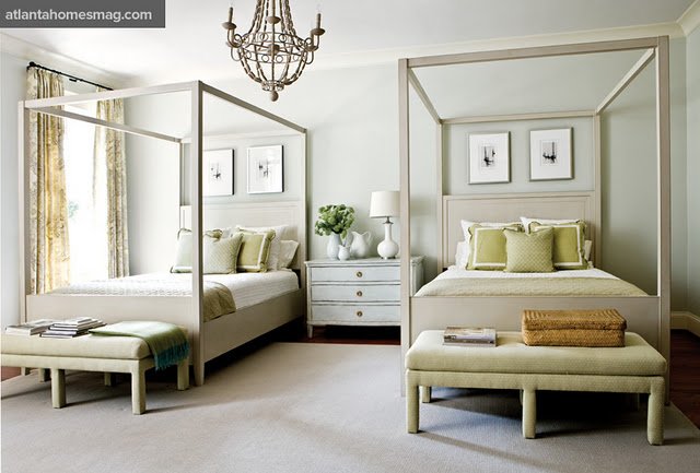A guest room with twin beds and a chandelier.