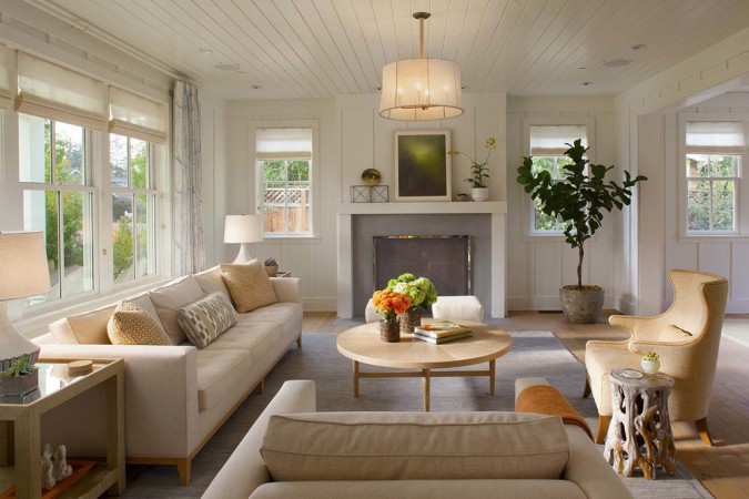 A living room with modern farmhouse style couches and a fireplace.