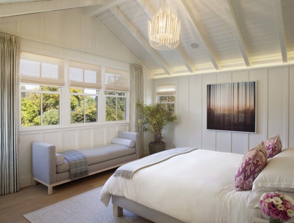 White painted wood walls and ceiling enhance the modern farmhouse bedroom 