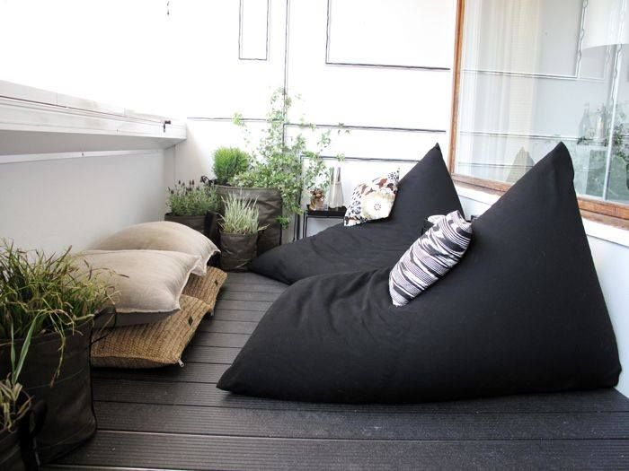 A comfy retreat with two black bean bag chairs on a balcony.