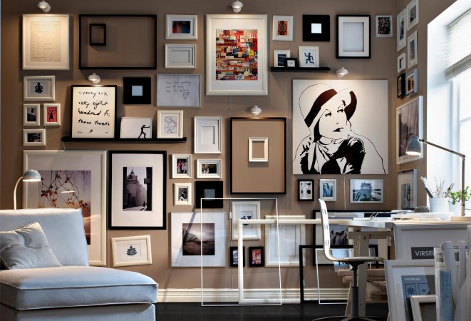 A room with many framed alternative pictures on the wall.