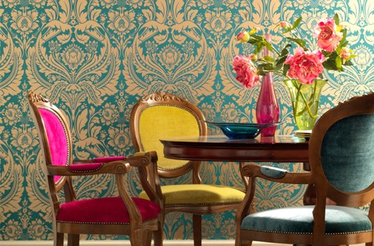 Different colored chairs bring a vibrant, festive feel to the dining room 