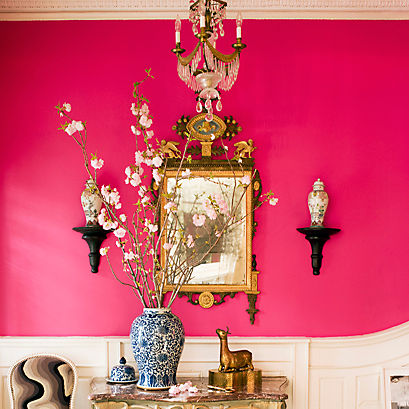 Bold fuchsia walls set the scene for a dramatic dining room