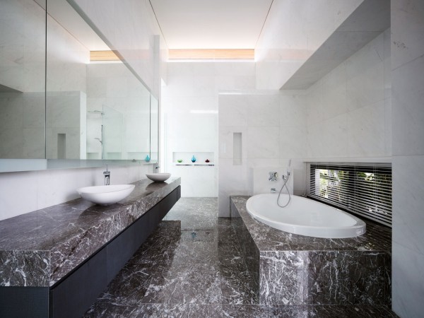 A modern bathroom with marble counter tops and sinks - 5 Reasons to Love Marble in Your Home.