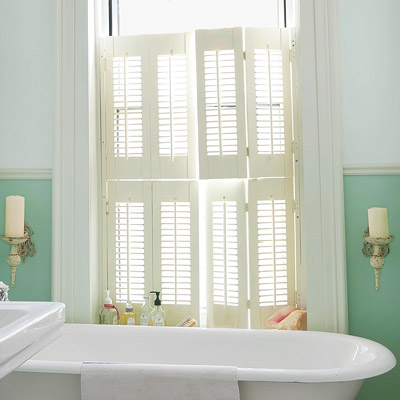 Beautiful split shutters enhance this charming bathroom