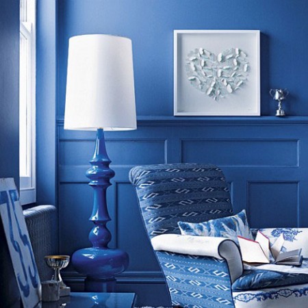 An Interior Design Tribute to Blue: A living room with blue walls and a blue chair.