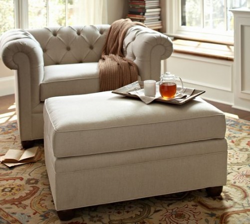 A chair and ottoman, two essential things that make a house a home, in a cozy living room.