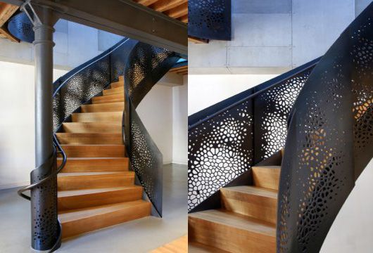 A trendy staircase made of metal with a perforated design.