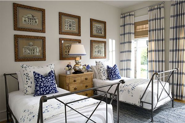 Two twin beds in a room with blue and white decor for the guest room.