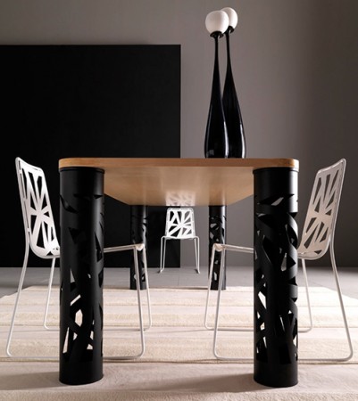 A dining table with perforated chairs in a trendy room.