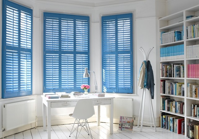 Shutters painted blue add color to this room 