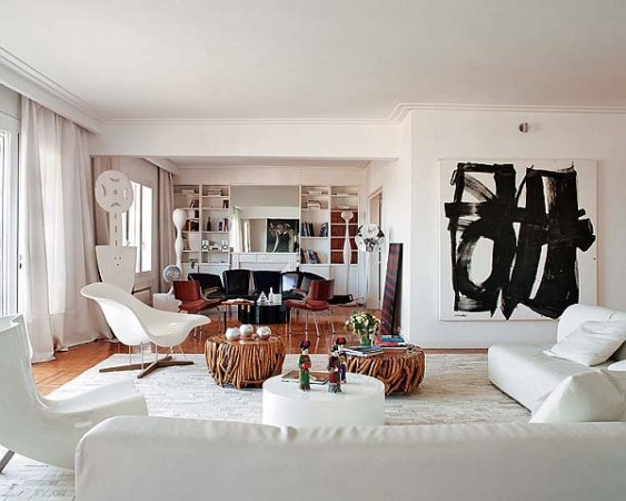 Unique abstract art and decorative objects contrast stylishly in this white room