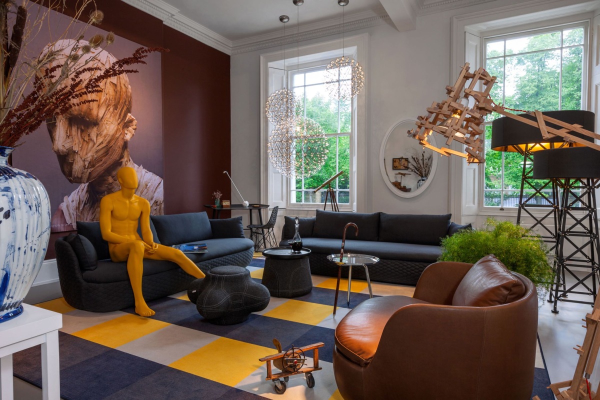 A living room with a bold and yellow statue in the middle of the room.