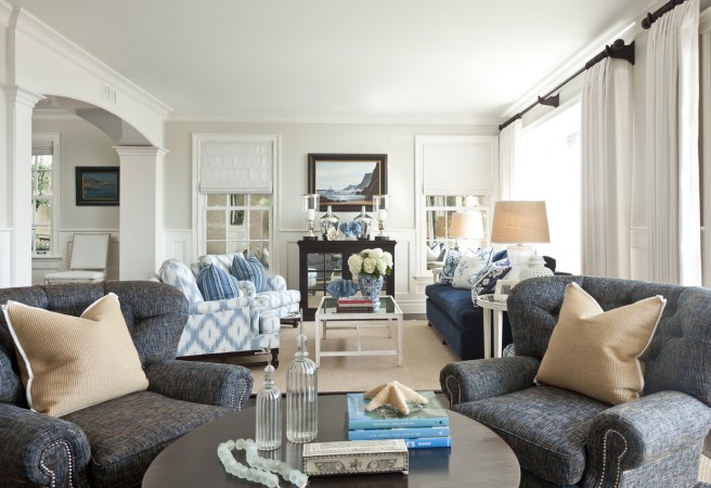 An elegant living room with understated coastal design featuring blue and white furniture.