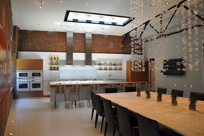 A modern kitchen with a large table and chairs in an unconventional home.