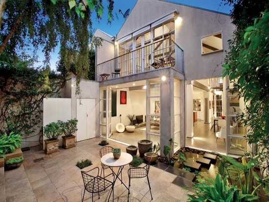 An unconventional white house with a patio and a garden, worth conversation.