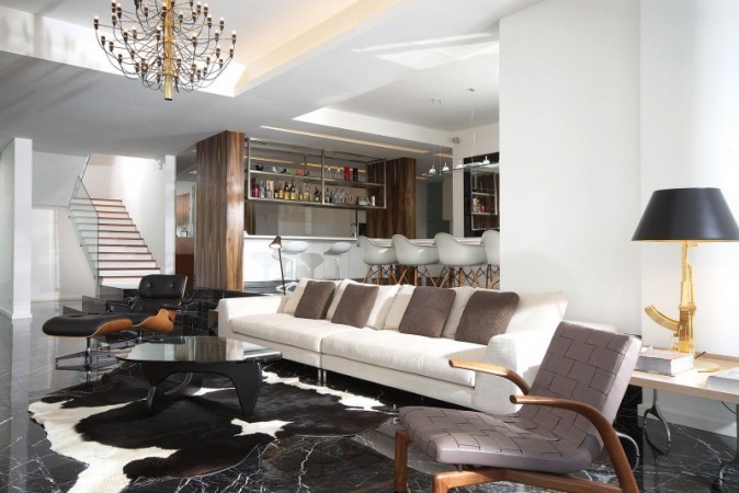 Marble living room featuring black floors and cowhide rug.
