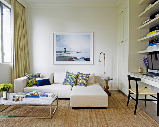 A living room with a white couch and a blue rug that breaks the mold.