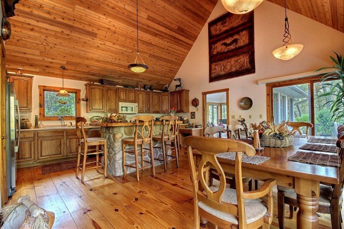 A lake home kitchen with wood floors and a dining table.