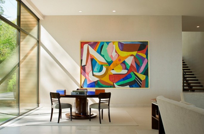 A modern living room with a colorful painting on the wall, perfect for art lovers of contemporary interiors.