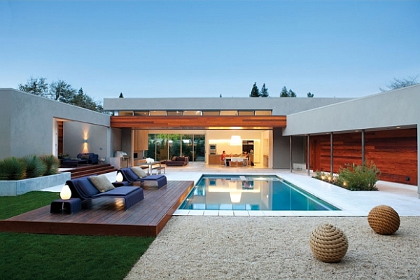 A stylish backyard oasis with a pool and lounge chairs for modern living.