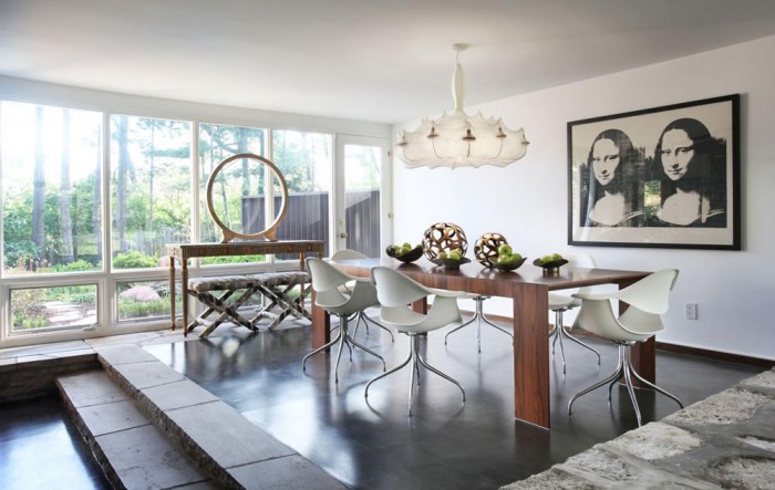 Artwork and a unique chandelier add personality to this modern dining space 
