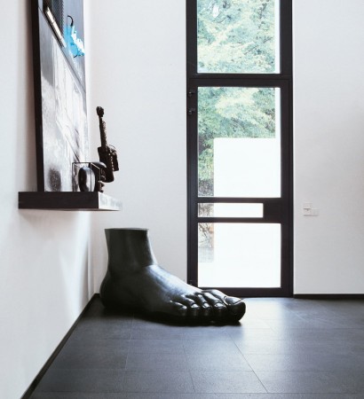 A modern sculpture in a room with a window for art lovers.