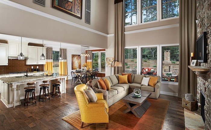 A lake house living room with a fireplace and large windows.