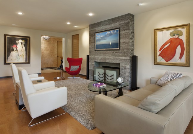 A modern living room with a fireplace, perfect for art lovers.