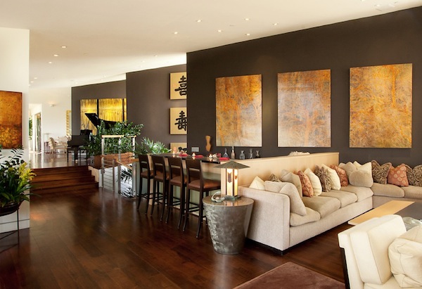 A modern living room with brown walls and wooden floors.