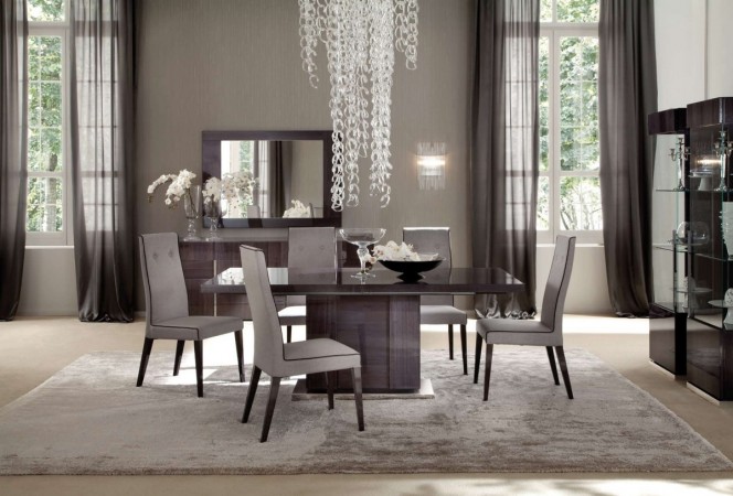 A beautiful flowing chandelier raises the elegance of this modern dining space