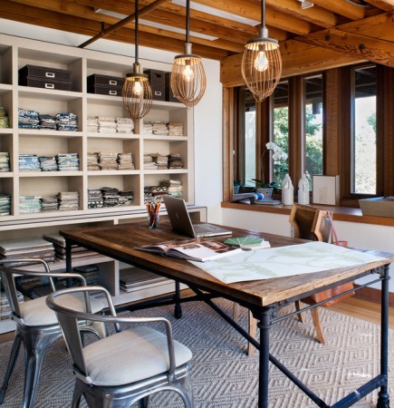An inspiring home office with a wooden table and chairs.