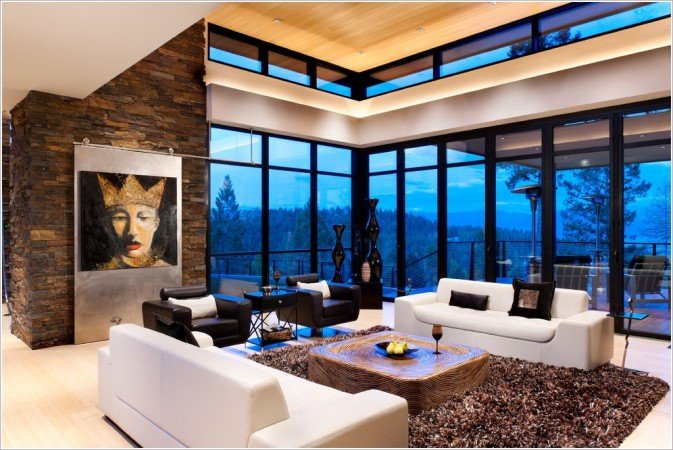 A lake home living room with large windows.