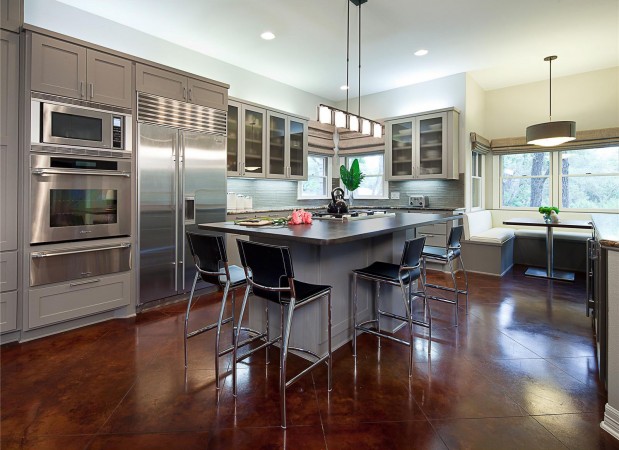 A modern kitchen with stainless steel appliances and a center island.